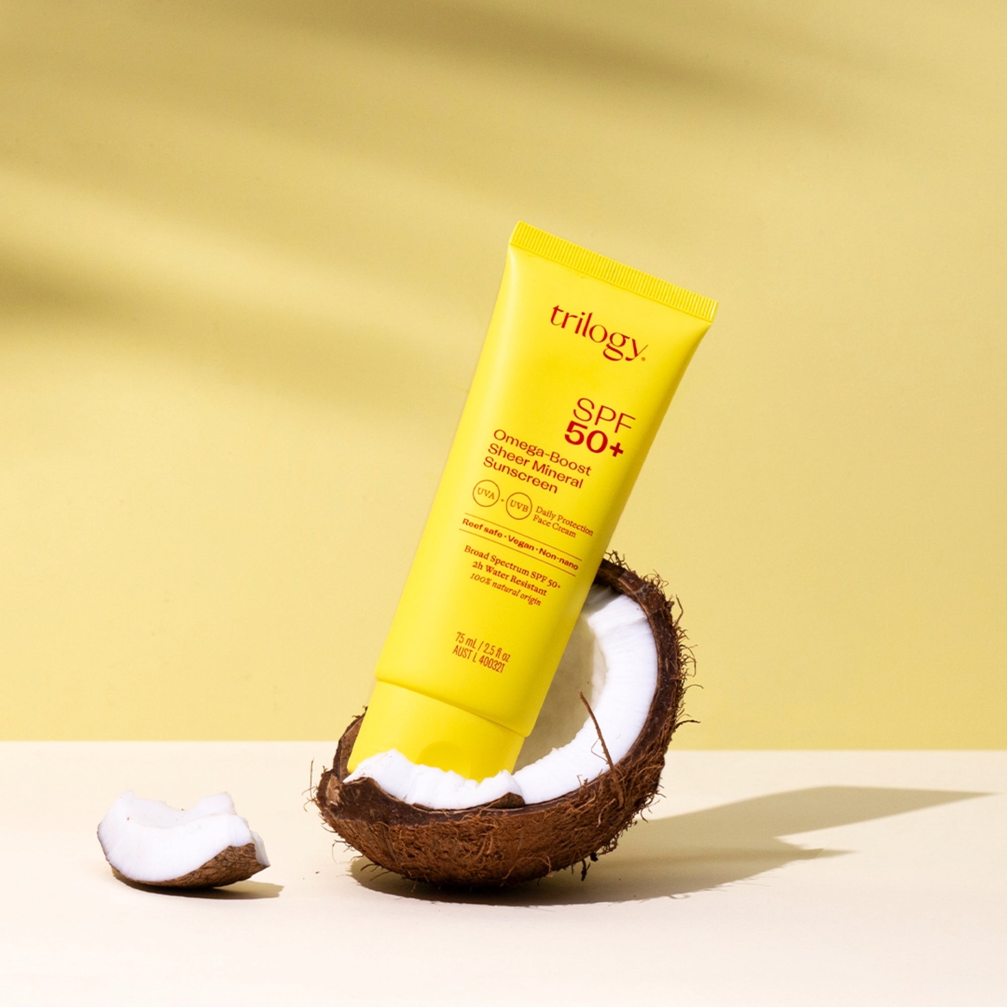 SPF 50+ Omega-Boost Sheer Mineral Sunscreen in a coconut shell.