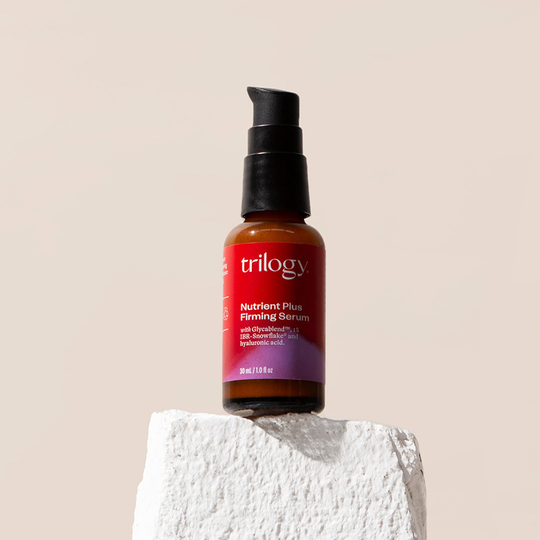 Nutrient Plus Firming Serum on a rock.