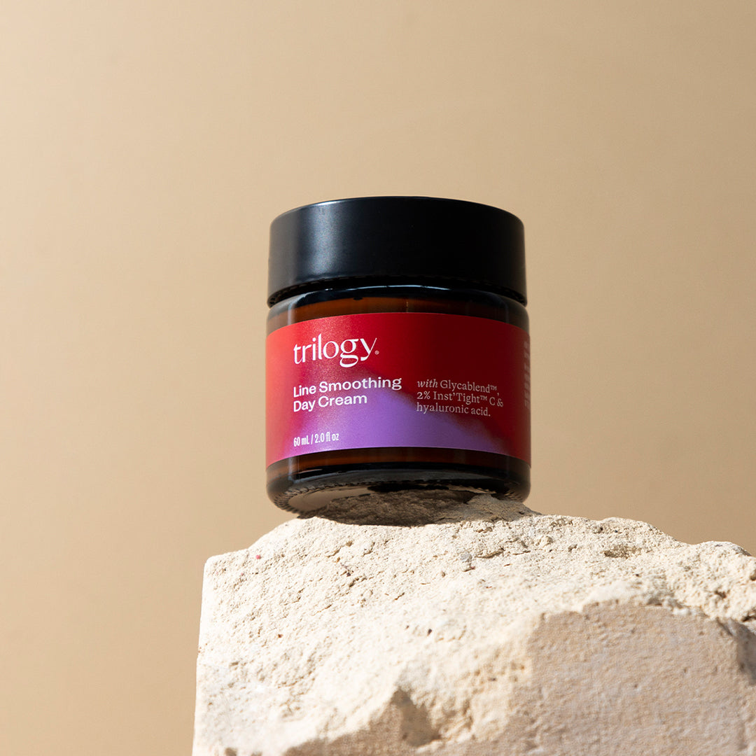 Line Smoothing Day Cream on a rock.
