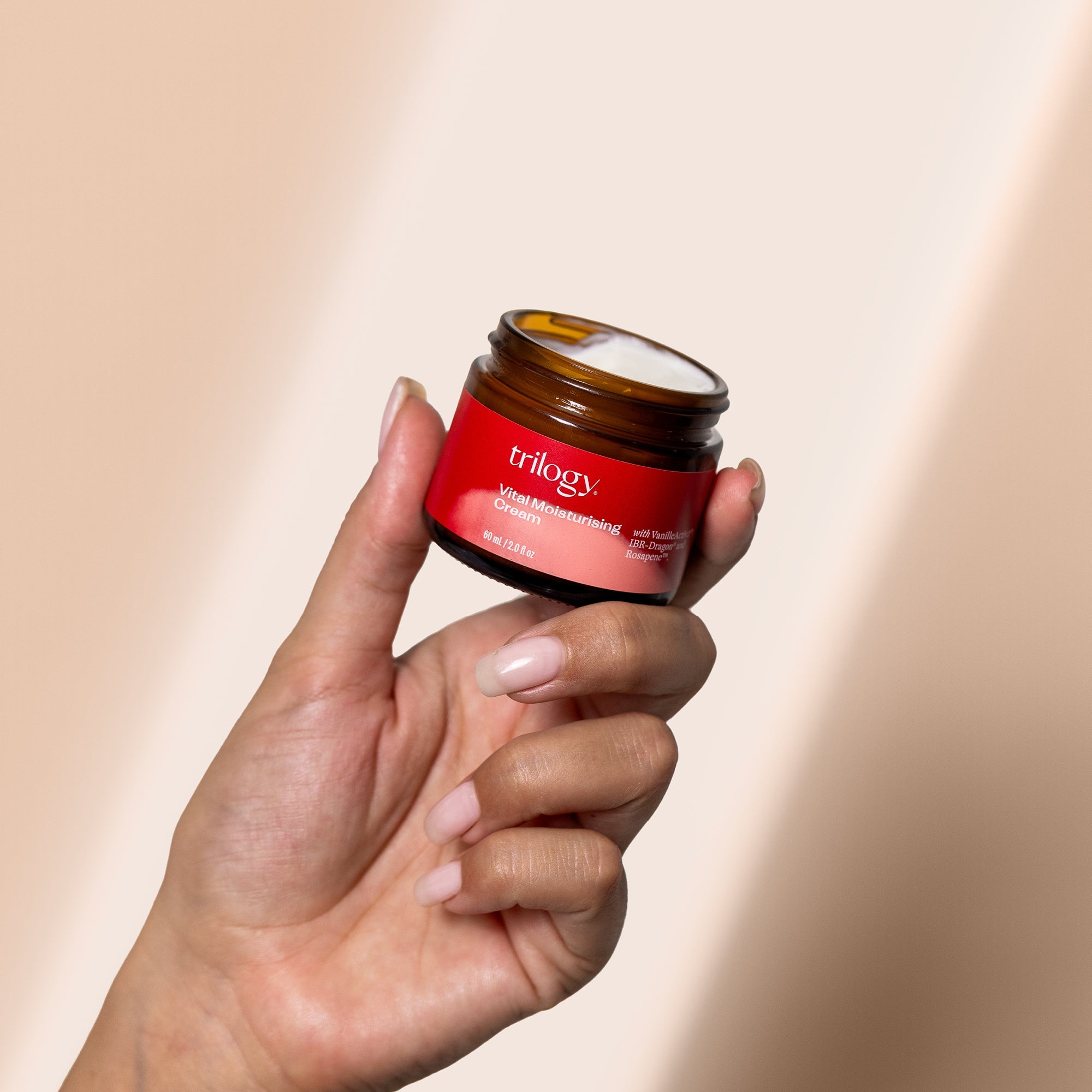 Vital Moisturising Cream product in hand with lid off to show texture.