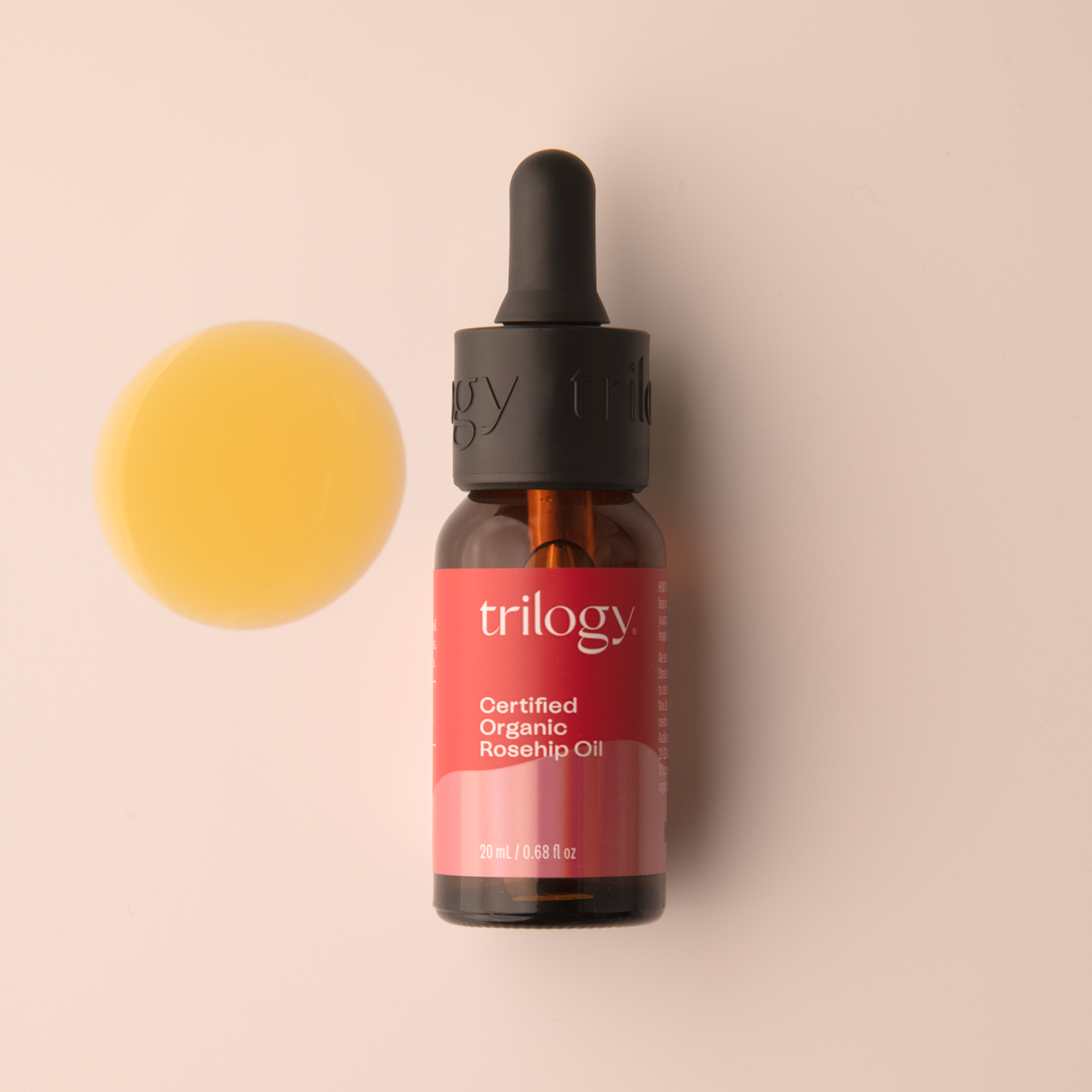 Trilogy Skincare Certified Organic Rosehip Oil 20mL with swatch on a beige background.