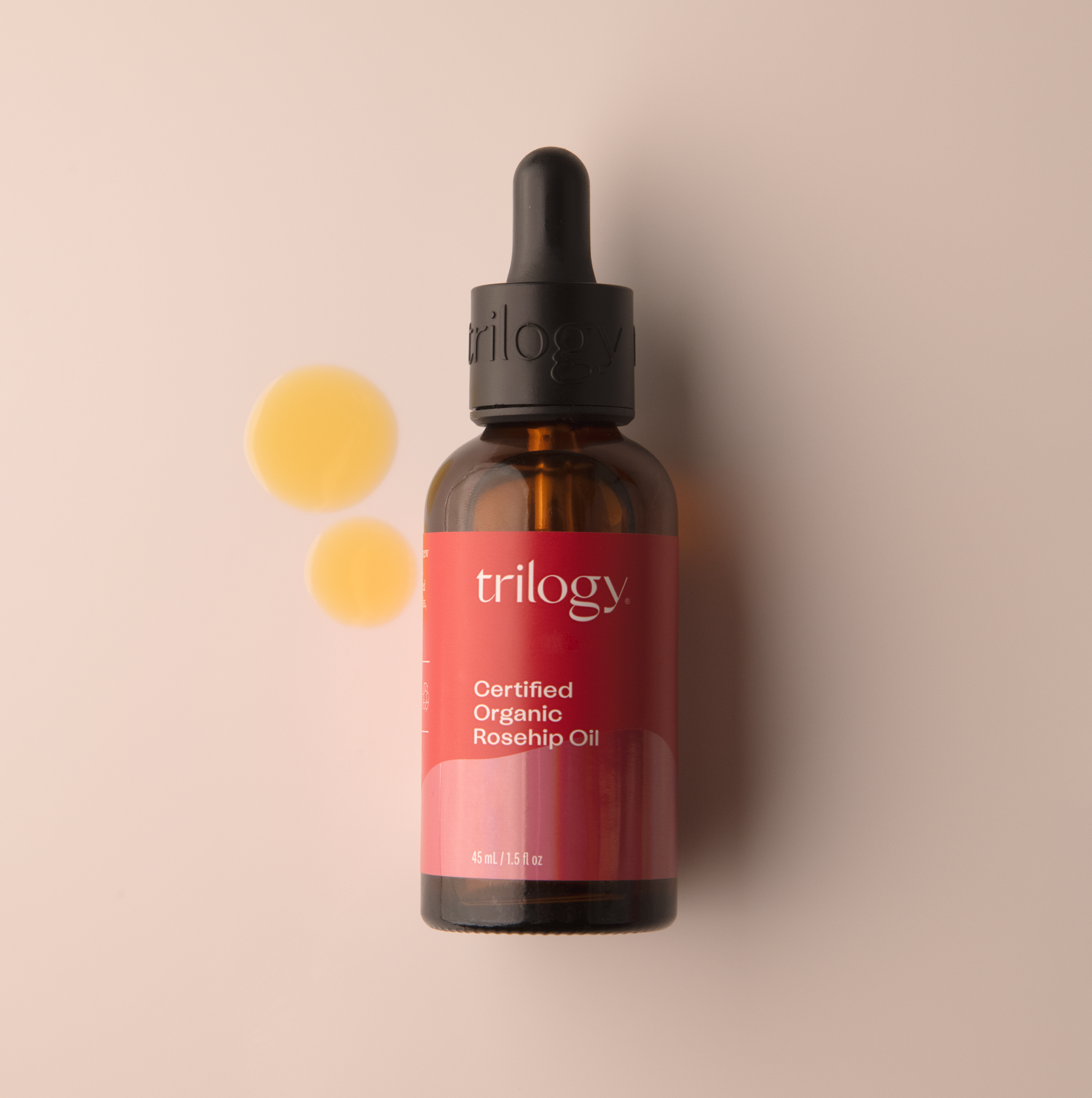 Trilogy Skincare Certified Organic Rosehip Oil, 45ml with swatch on a beige background.