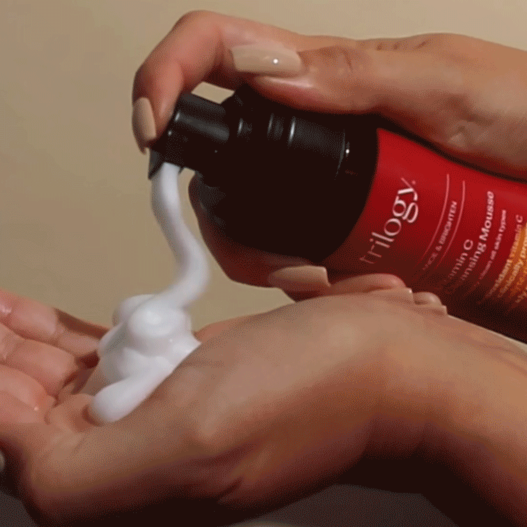 Vitamin C Cleansing Mousse being pumped out of the packaging and showing the outer benefit text.