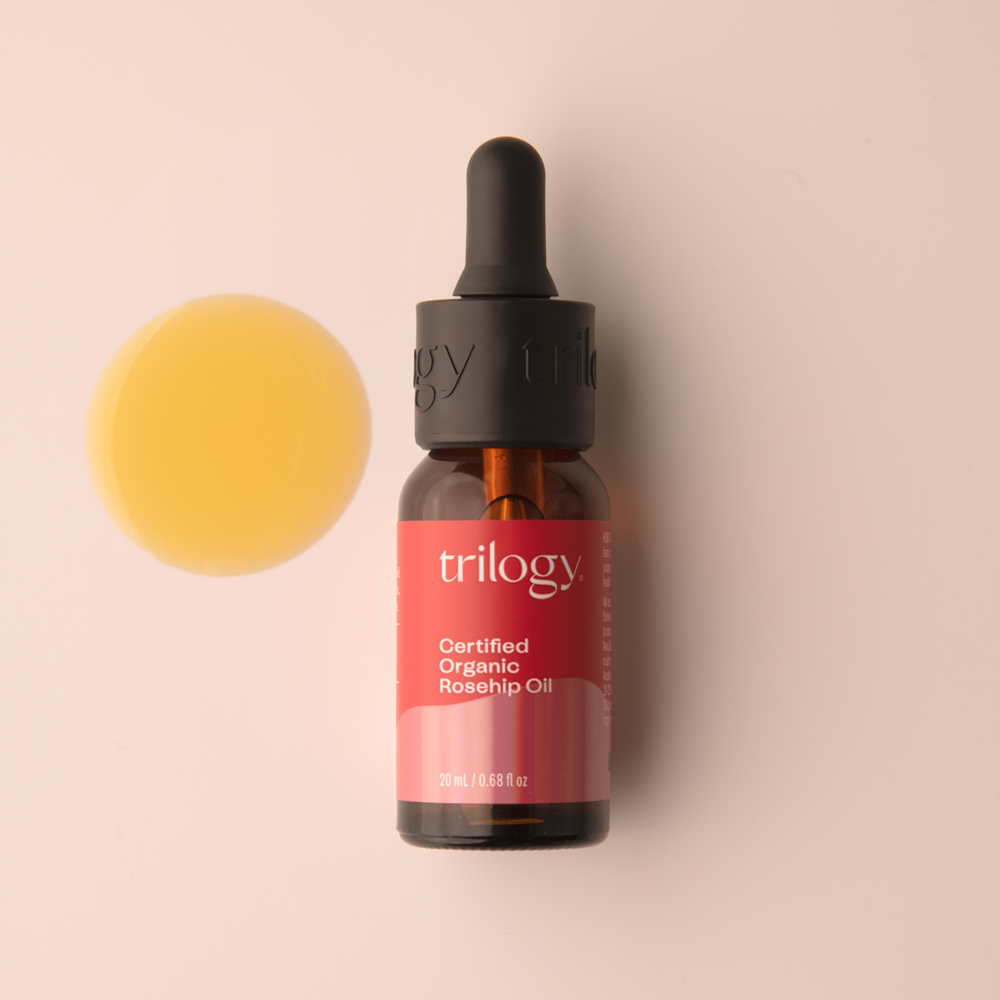 Trilogy Skincare Certified Organic Rosehip Oil 20mL with swatch on a beige background. 